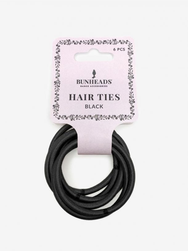 A package of Bunheads hair ties featuring six black, metal-free elastic hair elastics is displayed. The ties are neatly arranged and attached to a pink cardboard backing adorned with floral designs and the product name HAIR TIES.