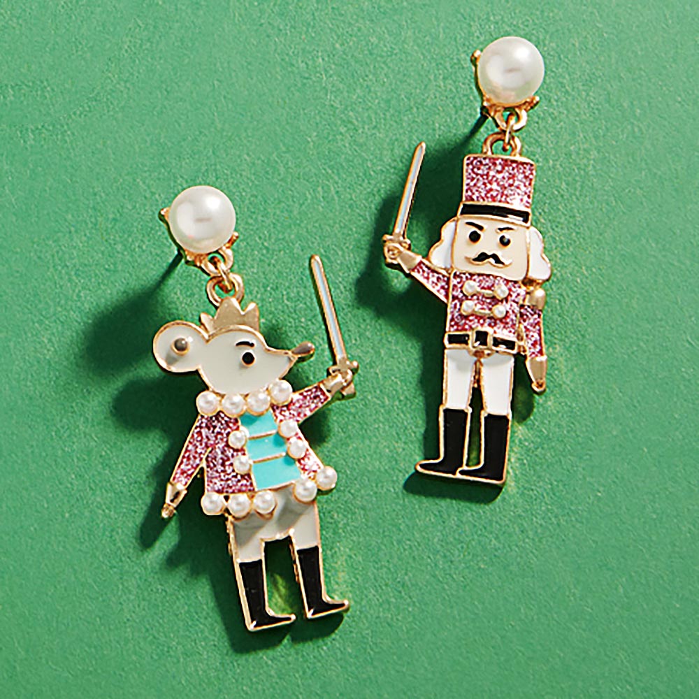 Whimsical Enamel Nutcracker Dangle Earrings feature a playful design with a mouse and a nutcracker, both adorned with sparkling details.