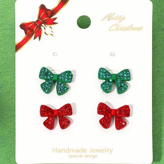 The image features a festive earring set titled Rhinestone Pave Holiday Bow Stud Earring Set, showcasing two pairs of stud earrings.