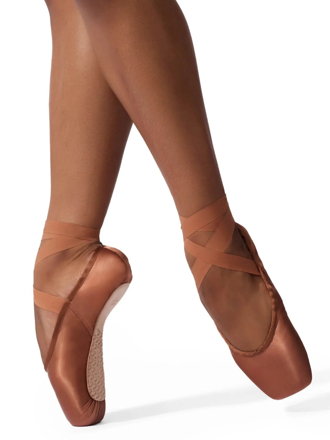 A dancers feet are shown wearing the 1142W (Ava) pointe shoes in a soft maple color. The shoes feature a satin finish and are secured with crisscrossed ribbons, highlighting their elegant design and functionality.
