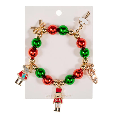A festive Nutcracker Bow Charm Beaded Stretch Bracelet features alternating red and green beads, accented with gold beads.