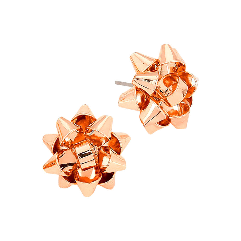 A pair of festive gift bow stud earrings in a shiny rose gold finish are displayed against a white background.