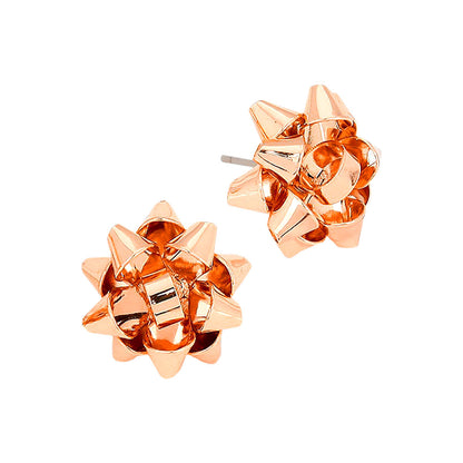 A pair of festive gift bow stud earrings in a shiny rose gold finish are displayed against a white background.