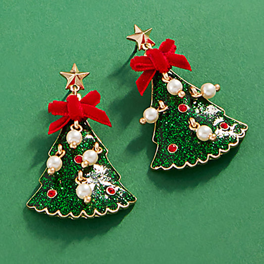 The image features a pair of Glittered Enamel Holiday Tree Dangle Earrings, showcasing a vibrant green tree design adorned with sparkling glitter.