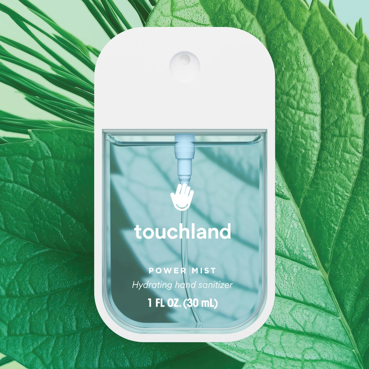 A bottle of Touchland Power Mist Hydrating Hand Sanitizer is prominently displayed against a backdrop of vibrant green leaves.