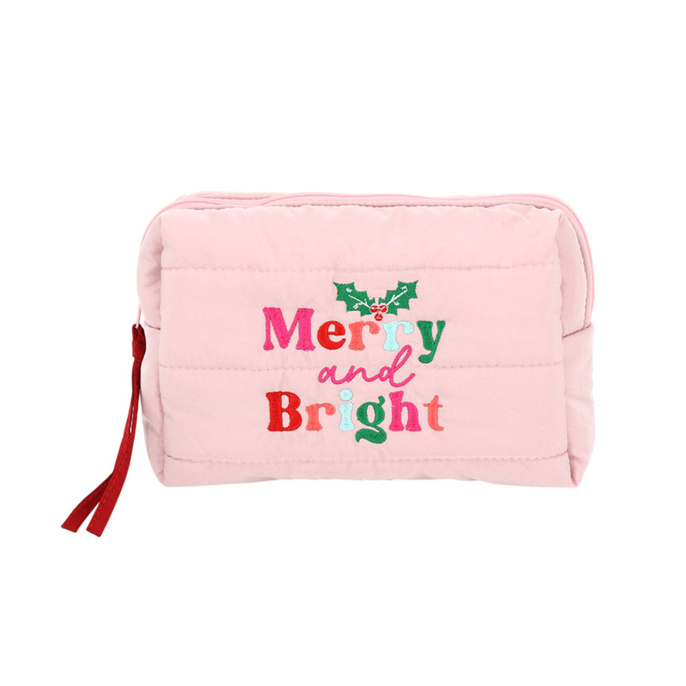The image features a pink quilted cosmetic pouch bag labeled Merry and Bright in colorful embroidered letters, accented by a holly design.