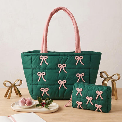 A green quilted tote bag with pink bow embroidery accents is prominently displayed, accompanied by a matching small pouch.