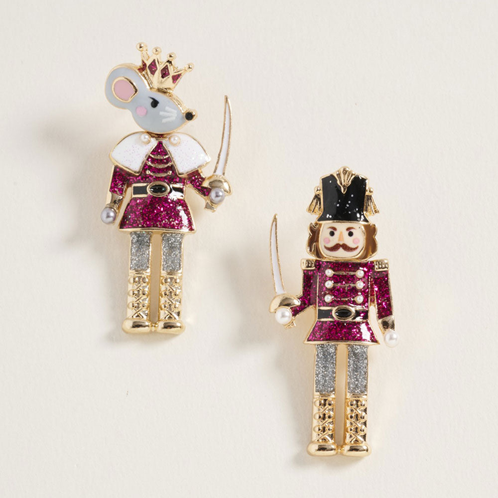 Whimsical earrings featuring a Nutcracker soldier and a Mouse King, each adorned with glitter accents in shades of pink and silver.