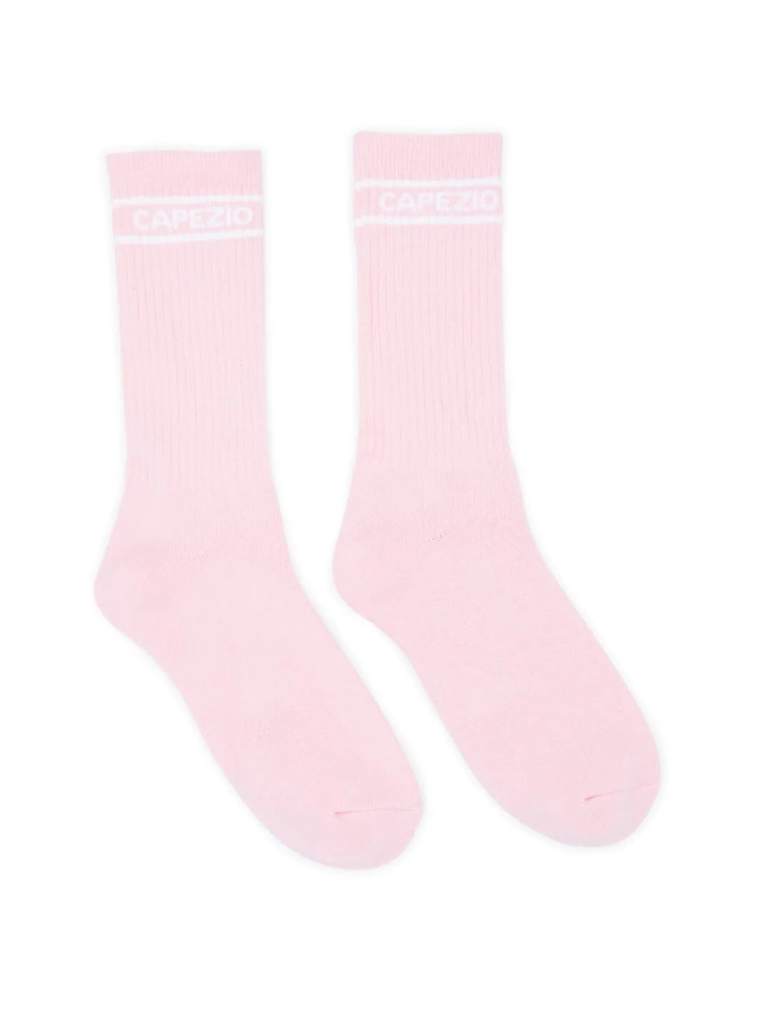 The image features a pair of Capezio Varsity Crew Socks in a soft pink color. These vintage-style crew socks showcase a ribbed texture and a prominent white Capezio logo at the top, making them ideal for both lounging and everyday wear.