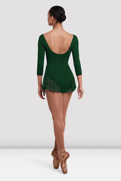 A dancer is shown from the back, wearing a dark green leotard with a deep U-shaped neckline and three-quarter sleeves.