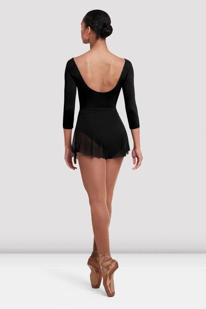 A model is seen from the back wearing a black Ladies Jaye Mesh Skirt by the brand, styled with a fitted leotard.