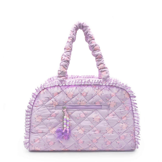 This image features a Lilac Quilted Floral Printed Medium Duffle Bag, showcasing a soft lavender exterior adorned with delicate floral prints.