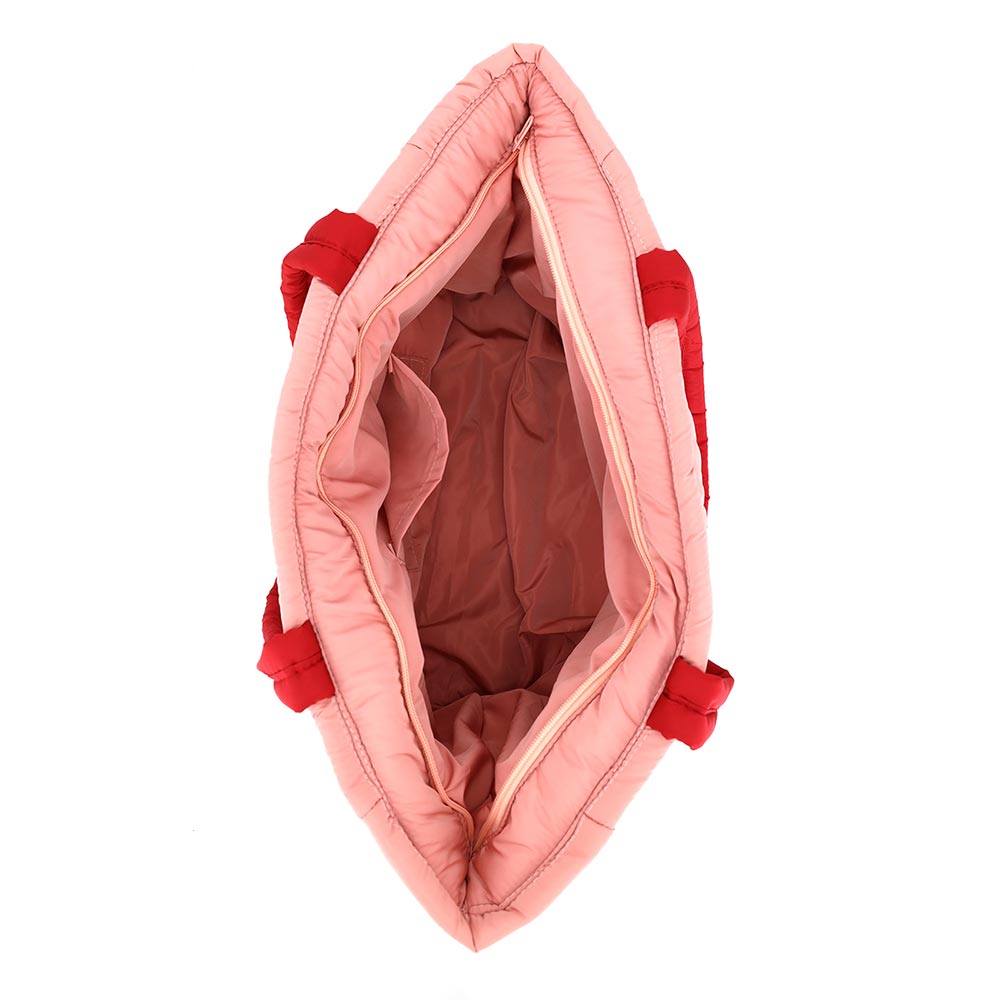 The image shows the interior of a Nutcracker Holiday Candy Cane Embroidered Quilted Tote Bag, featuring a spacious main compartment lined in soft fabric.