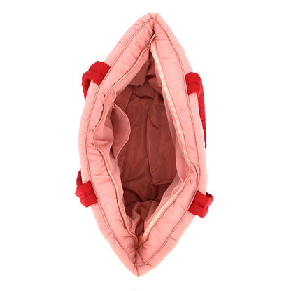 The image shows the interior of a Nutcracker Holiday Candy Cane Embroidered Quilted Tote Bag, featuring a spacious main compartment lined in soft fabric.