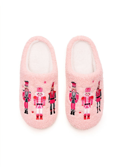The image features a pair of Living Royal Adult Nutcracker Slippers in soft pink, showcasing a cozy, fuzzy texture.