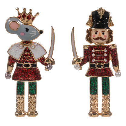 A pair of glittered Nutcracker Ballet earrings featuring a Mouse King on the left and a Nutcracker soldier on the right.