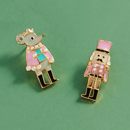 Whimsical Nutcracker Ballet Stud Earrings showcase a playful design featuring a mouse king in a pink outfit and a nutcracker soldier with a top hat.