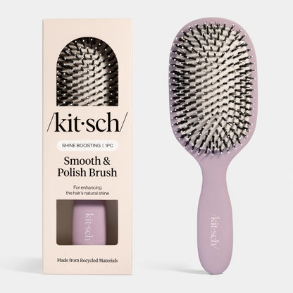 A Kitsch Smooth & Polish Brush in a soft lavender color is displayed next to its packaging, which features a cream background.