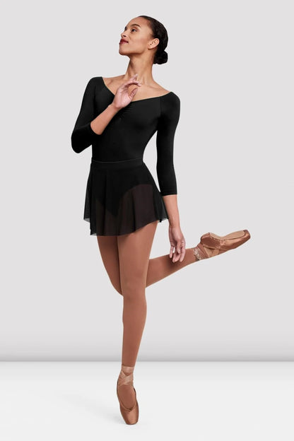 A dancer showcases the Ladies Jaye Mesh Skirt (R4211) in black, featuring a soft elasticated waistband and a short mesh design.